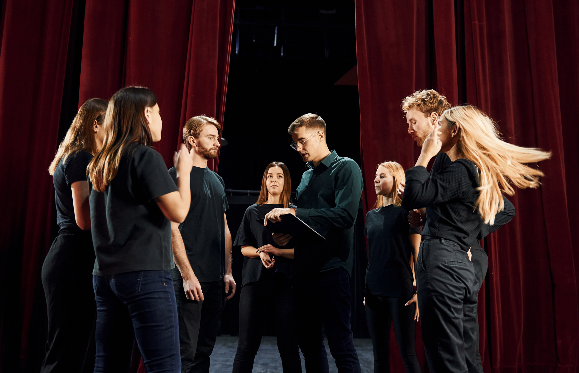 Group of Actors in Dark Colored Clothes on Rehearsal in the Theater